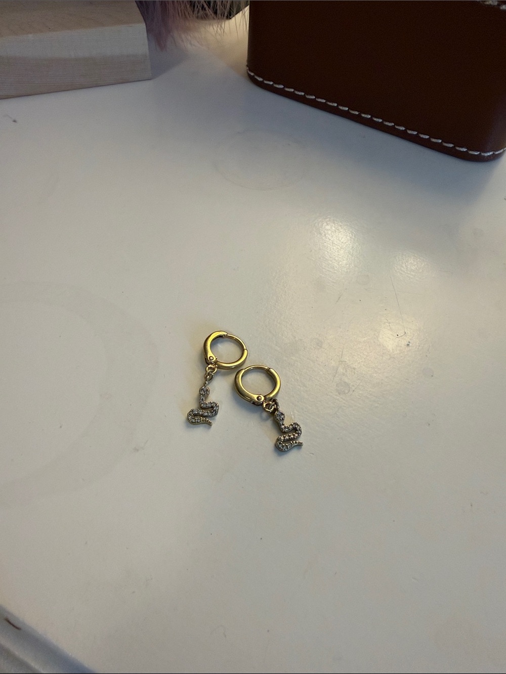 Gold Tone Huggie Hoop Earrings with Pavé Snake Charms